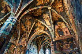 Wnętrze gotyckiej Kaplicy Trójcy Świętej na Zamku Lubelskim z żebrowym sklepieniem i XV-wiecznymi bizantyjsko-ruskimi freskami przedstawiającymi sceny biblijne, aniołów i świętych.