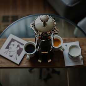 french press with coffee cups on coffee