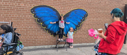 People standing for a photo with butterfly wings