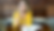 Woman in yellow shirt looking off in the distance while sitting at table holding pen