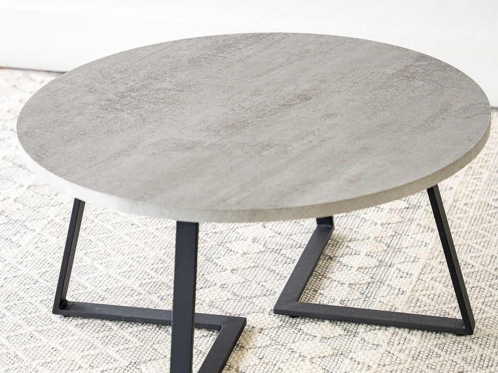 Concrete top black v-shape metal base round coffee table top view