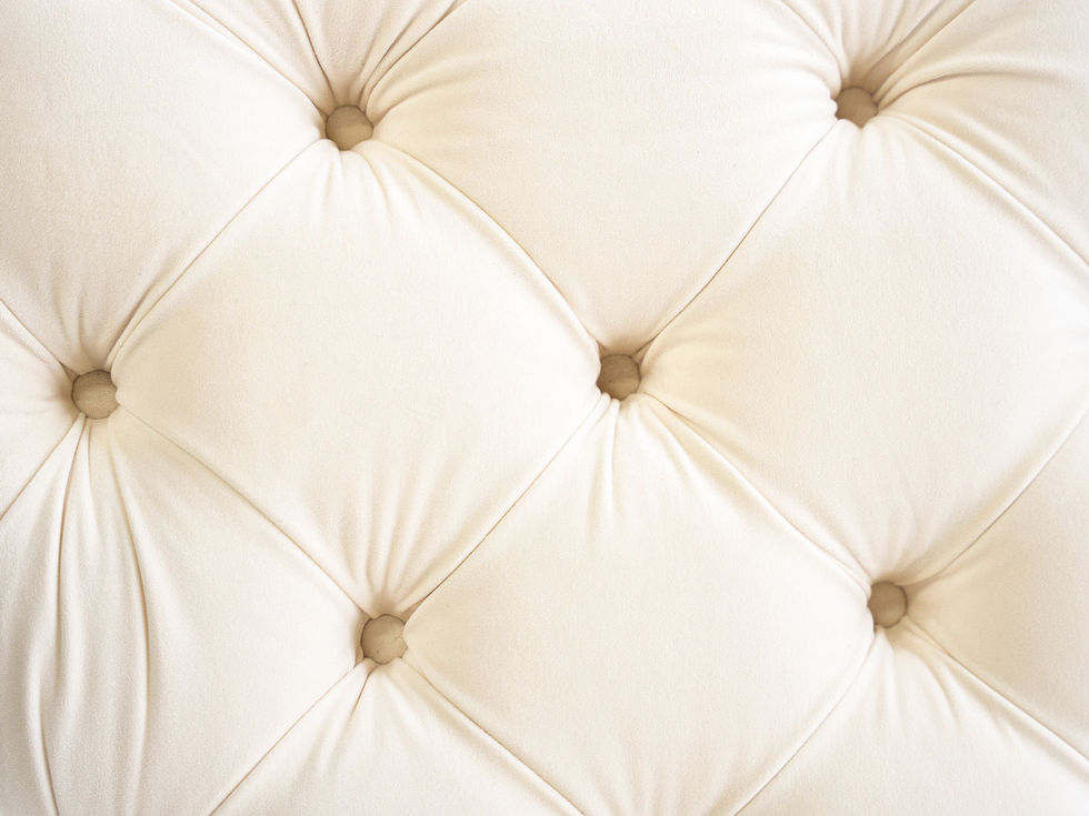 close up tufted ivory upholstery ottomans