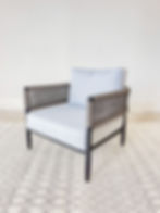 Warm grey woven outdoor arm chair light grey cushions angle view