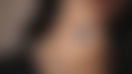 Sapphire engagement ring in an elegant solitaire setting worn on hand in soft natural light