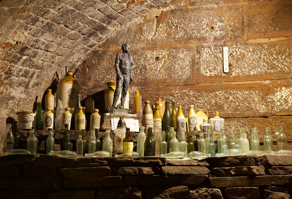 Found bottles and a statue of Joseph Williamson displayed in one of the re-excavated tunnels