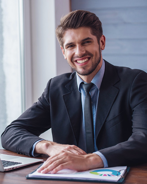 Smiling financial professional seated at a desk, representing confidence, clarity, and business growth