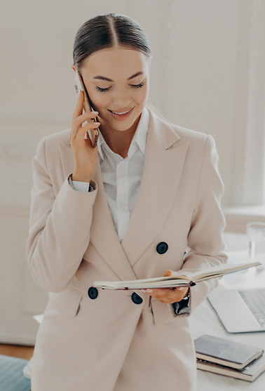 Executive managing client communication while reviewing strategic notes