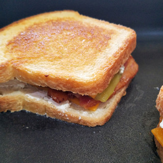 Lower the heat if you need to and continue to grill the sandwiches until the cheese is melted and the bottom is grilled to a golden brown.