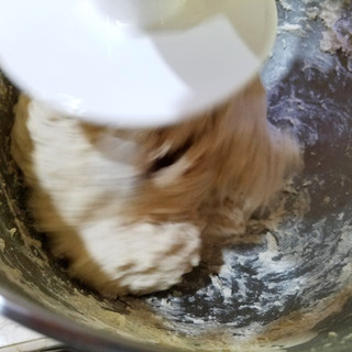 Mix until the dough comes together. Start with one cup of water then add 1 tablespoon at a time if necessary.