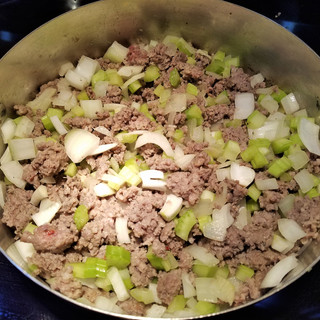 Add the celery and onions to the pork and saute until wilted.