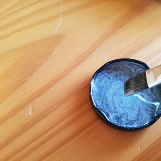 Use a clean paint brush to mix and paint with. I bought a set from wilton specifically for cookie and cake decorating.