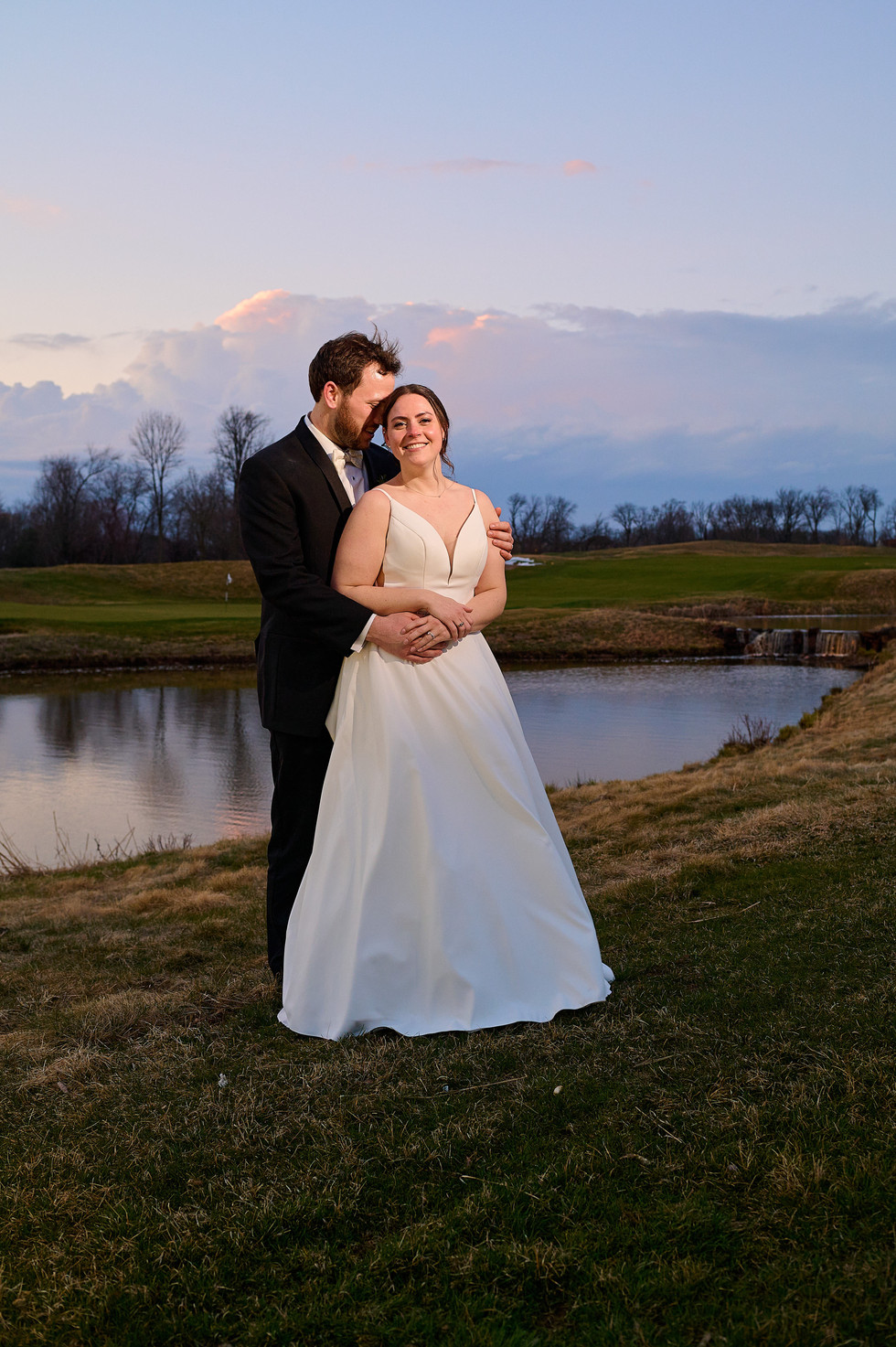 bride and groom embracing each other rivercrest