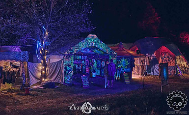 Artisan Alley market at night with UV lights, bright colours and handmade decorations