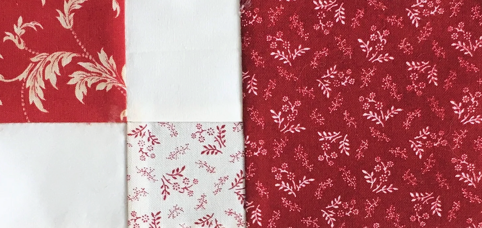 Five fabric squares sewn together, four small squares forming a larger square joined to one full square