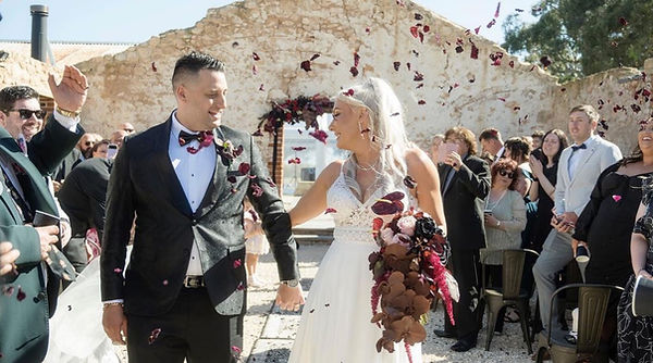 Married at Last.  Couple walking out of venue after exchanging vows, and married