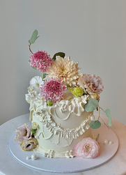 Elegant custom cake with vintage piping and fresh flowers