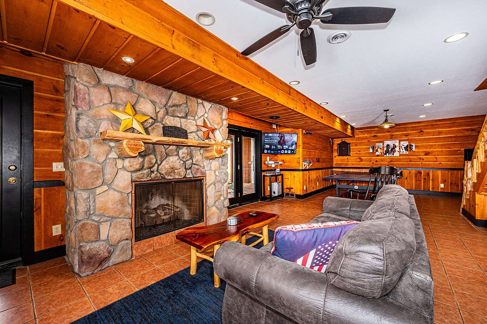 Alternate view of lounge area and fireplace in game room