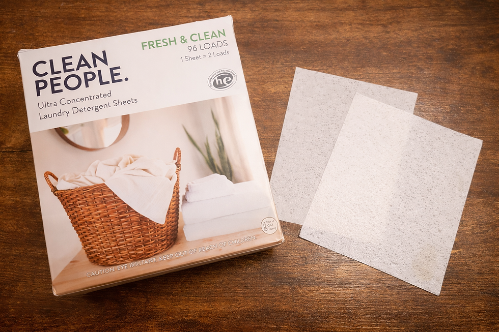 box that says "Clean People" and has an image of a clothes basket and laundry next to two white square sheets on a wood table