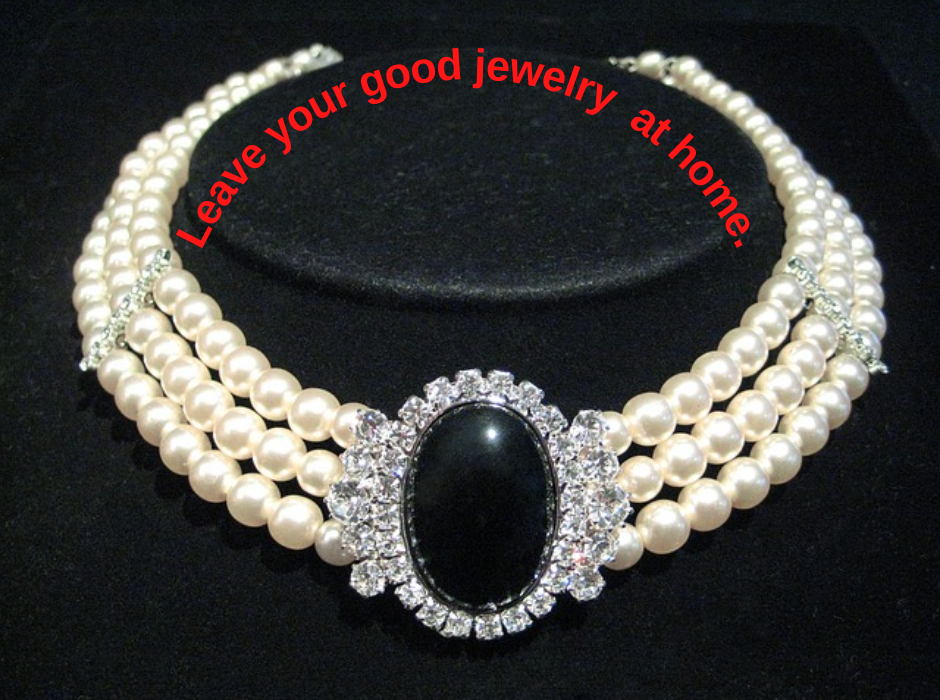pearls on black background with quote saying "leave your good jewelry at home."