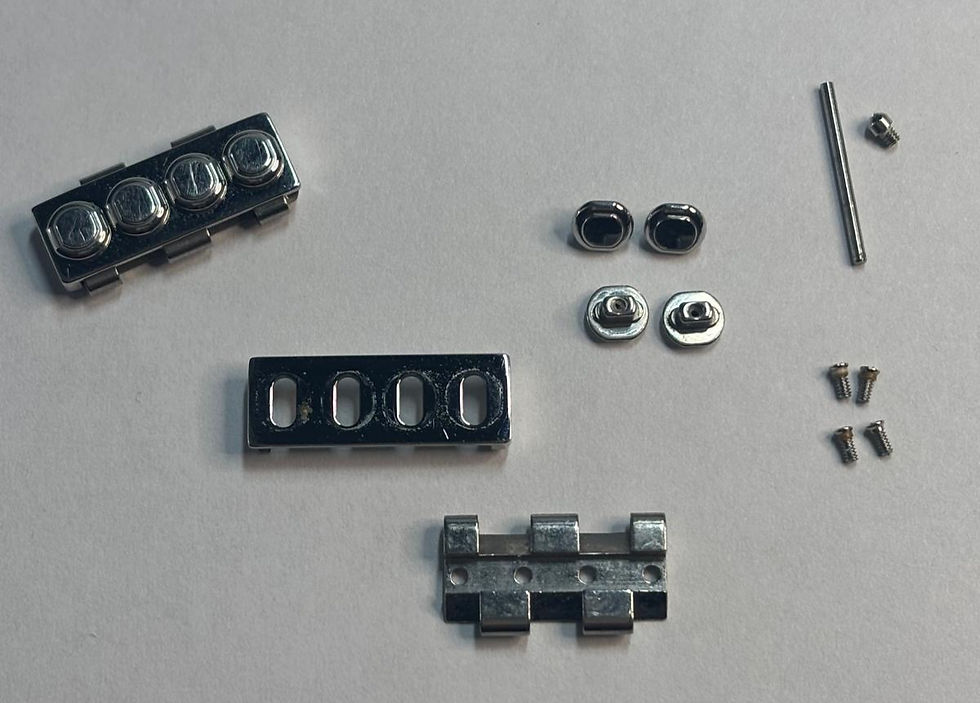 Disasembled bracelet link showing all the individual components.