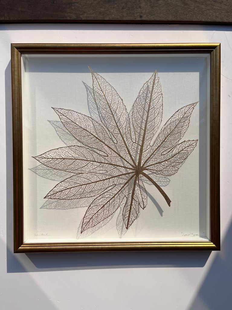 Mounted papercut art piece castor oil leaf