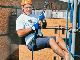 Garry in his harness at the top of Queen’s Medical Centre in Nottingham, just about to lower himself down for the abseil.