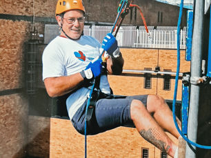 Garry in his harness at the top of Queen’s Medical Centre in Nottingham, just about to lower himself down for the abseil.