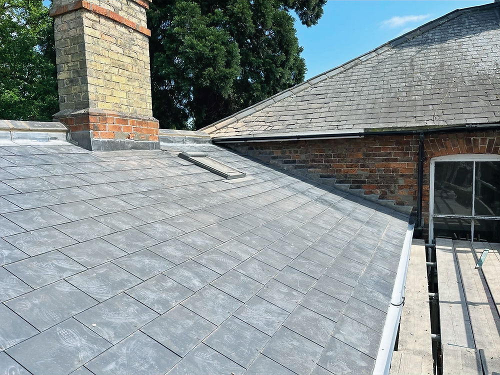 Slate re-roof Boston Lincolnshire on a brick house with chimney.
