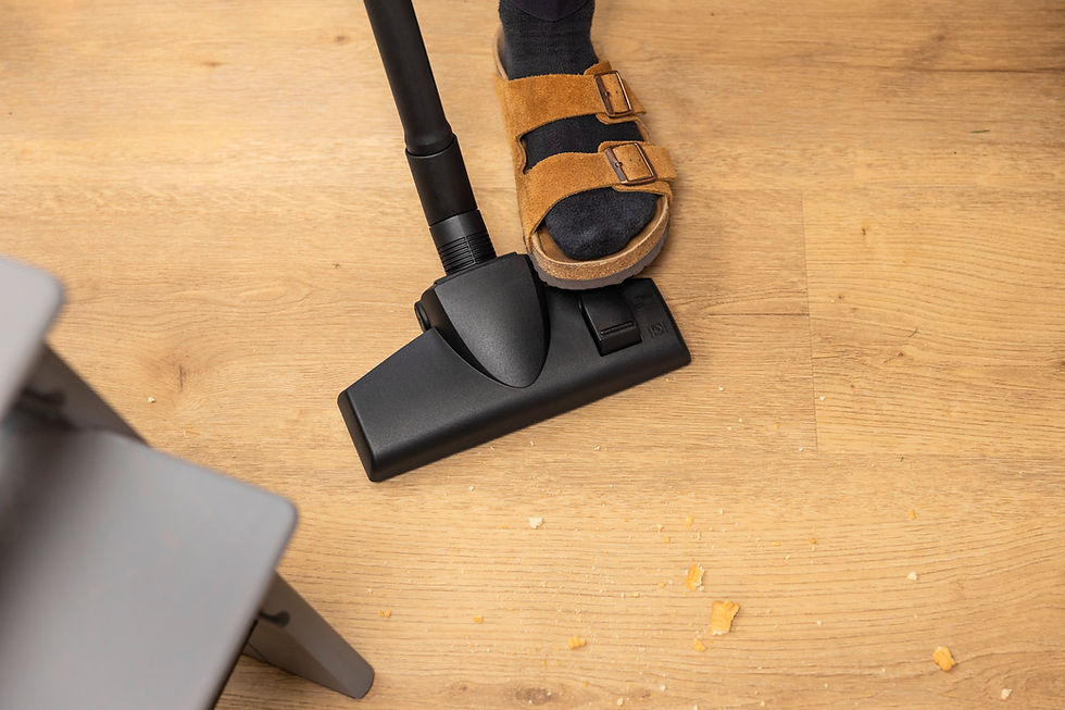 Thumbnail: Vacuum cleaner head and sandal on a wooden floor cleaning crumbs.