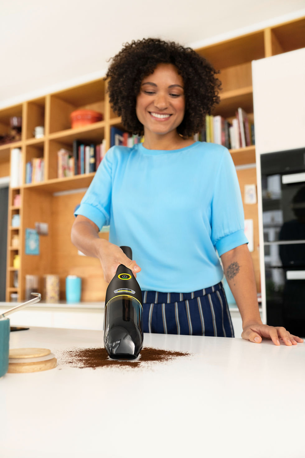 Thumbnail: Woman using a Kärcher AF 20 vacuum cleaner on a kitchen countertop FocusShop