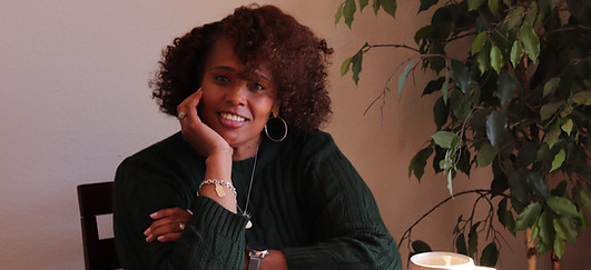 Tiffany Thompson smiling while working at her desk.