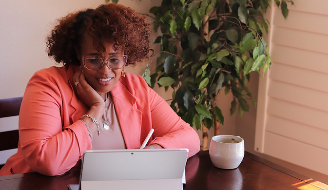 Tiffany Thompson working at her desk while reviewing client documents.