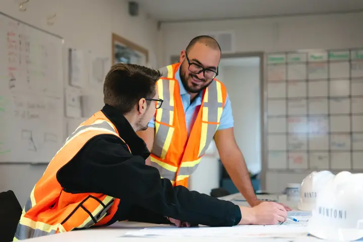 Two construction workers working on a project