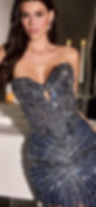 a person wearing a strapless, dark, sweetheart-neckline dress heavily embellished with sequins and beading in an intricate pa