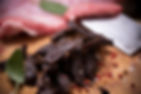 Beef Jerky on wooden background close up.jpg