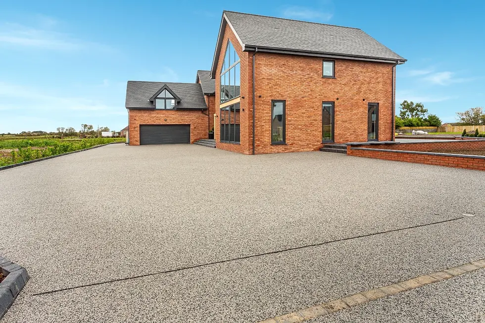 Modern resin bound driveway in Perth with clean, seamless finish and landscaped surrounds.