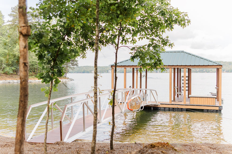 Wooden dock with a roof and metal ramp on a calm lake displaying LakeEze accessories