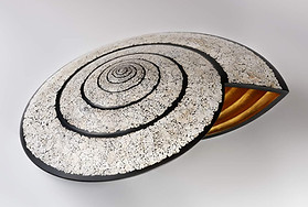 decorative sculpture in lacquered wood with eggshell inlay and interior covered with gold leaf inspired by the shape of the snail