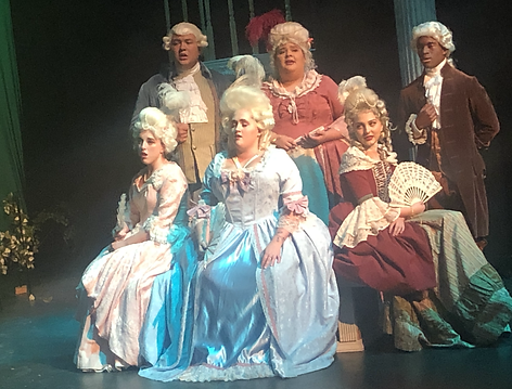 Alexander Laiche (both red coats), Peter Adendorff (Green coat and white wig), Anthony Voiers (blue coat with blonde wig) Timothy Sam (brown coat), Maria Cruz (blush pink dress) Natalie Broussard (both red dresses), Victoria Thomas (pink dress), Madison Russell (both blue dresses) in wigs by Jax Cornett