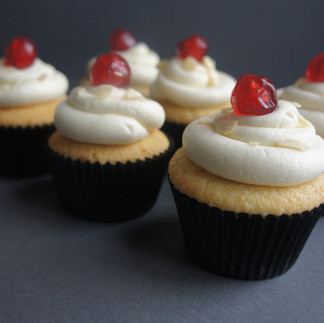 Cherry Bakewell cupcakes topped with almond buttercream and glacé cherries