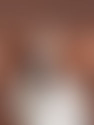 Basset hound with large, floppy ears spread wide, set against a plain brown background, creating a whimsical and amusing mood.