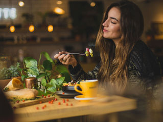 woman sitting at a table eating