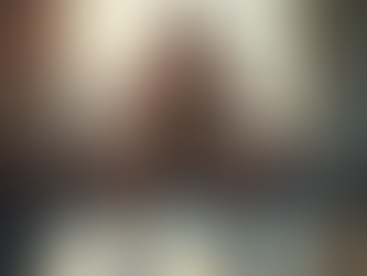 Man performing dumbbell squats at home with natural light streaming through a window, demonstrating strength training for fat loss.