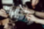 Des convives élégants portent un toast avec des verres de vin, symbolisant l'amitié et la célébration.