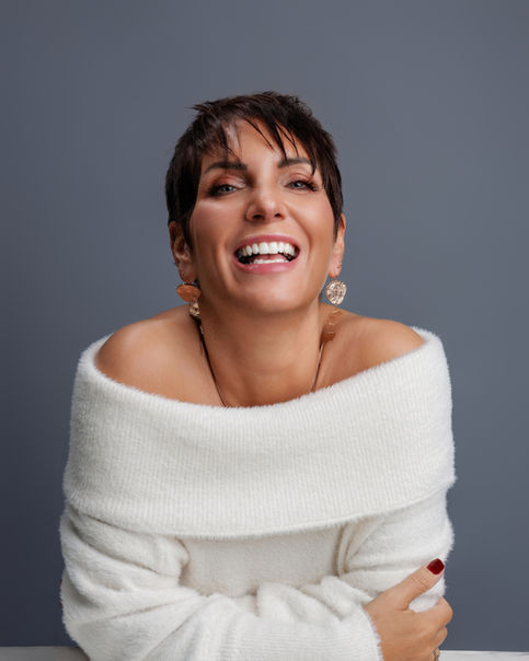 Joyful studio portrait of a woman photographed by a Bristol-based portrait photographer