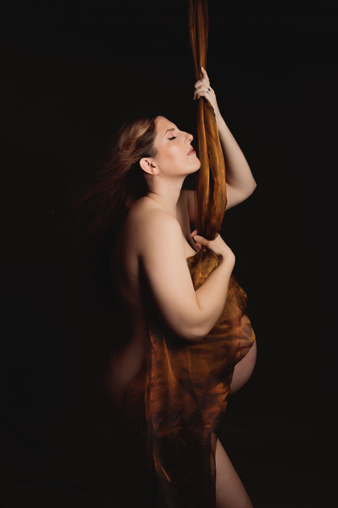 pregnant woman posing with suspended fabric artistic maternity photographer Bristol studio