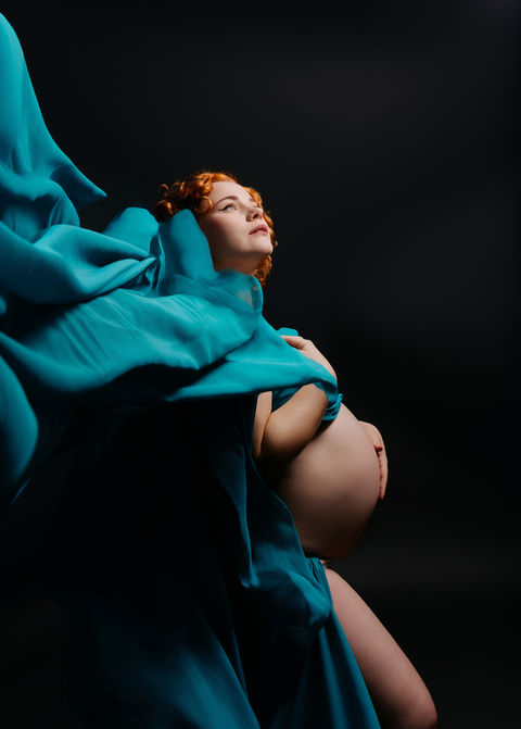 pregnant woman wrapped in teal fabric dramatic maternity photographer Bristol