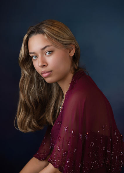 Portrait of a teenage girl photographed in a Portishead studio, using soft lighting and a relaxed, natural pose.