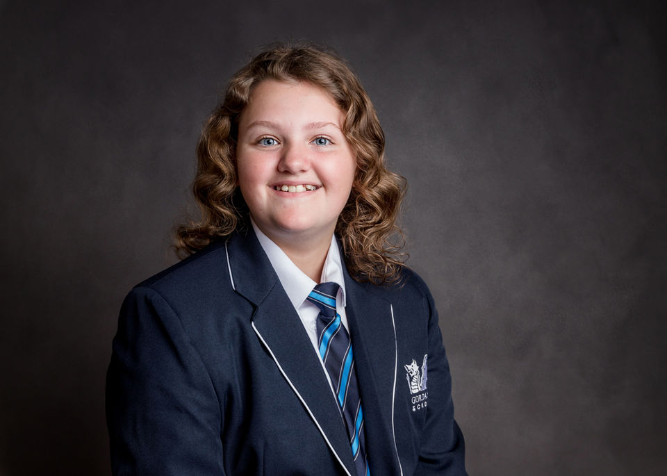 Secondary school student in blazer photographed for a confident studio school portrait in Portishead near Bristol.