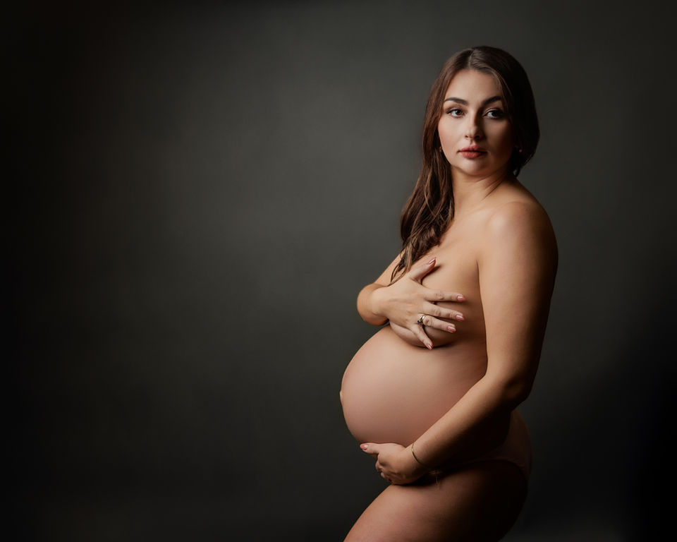 natural nude maternity portrait pregnant woman holding baby bump Bristol maternity photography